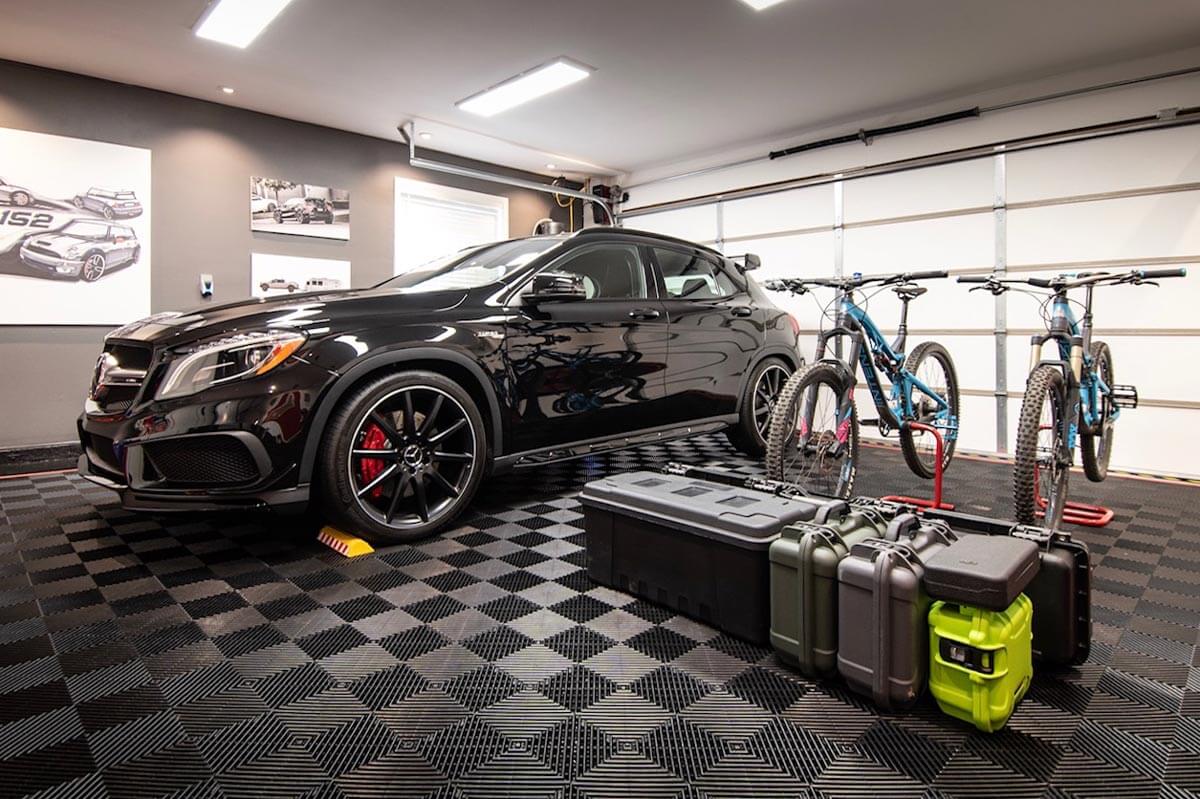 Black car on black garage flooring