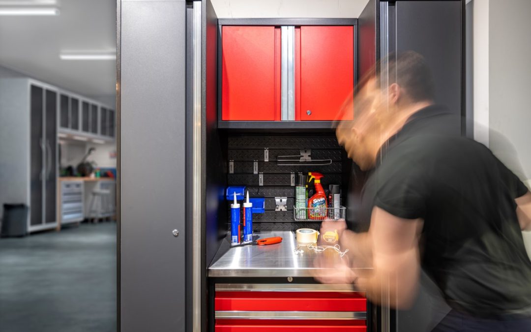 Man in front of red garage cabinetry