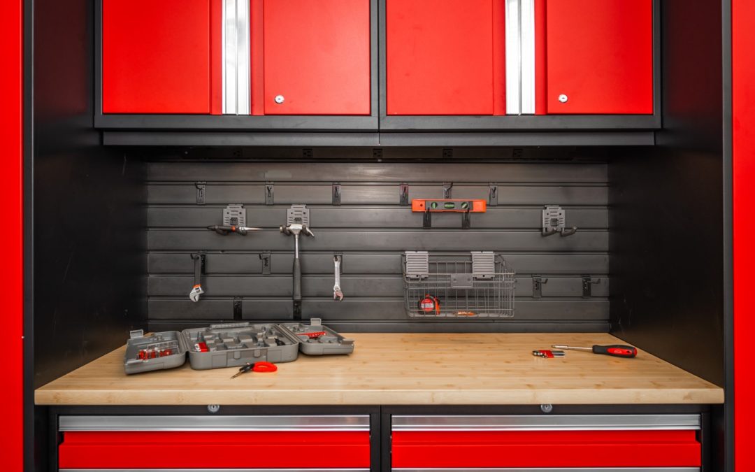 Garage with red cabinets tools on slatwall