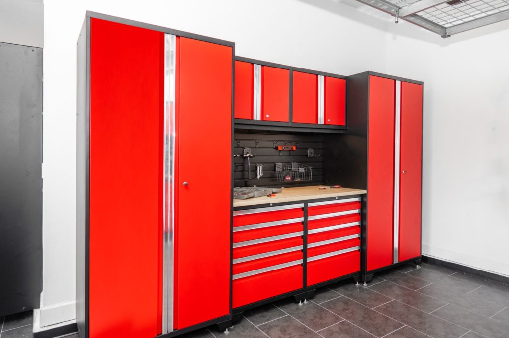 Garage with red cabinets and black flooring