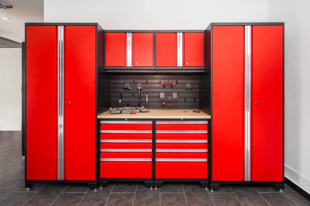 Garage with red cabinets and black flooring