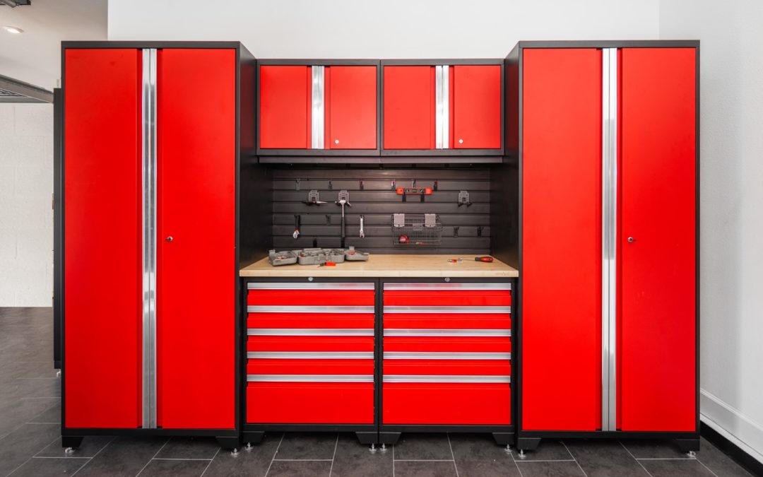 Garage with red cabinets and black flooring