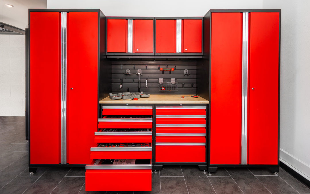 Garage with red cabinets and black flooring