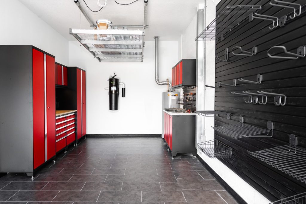 Garage with red cabinets and black flooring