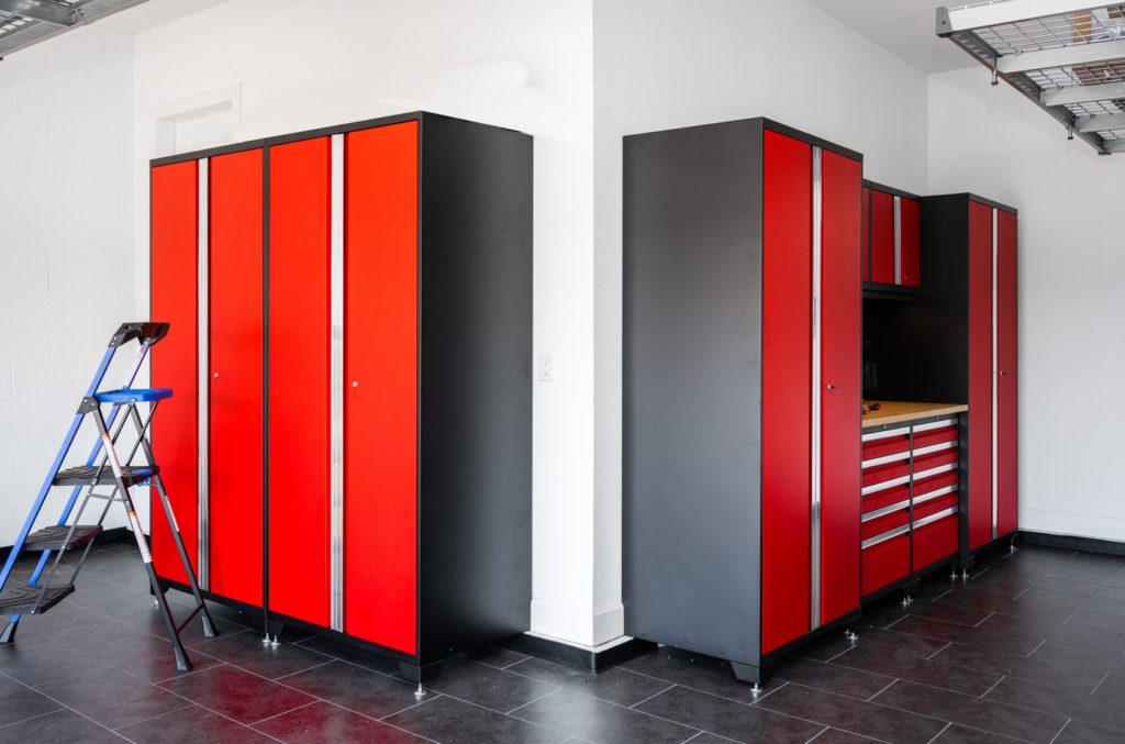 Garage with red cabinets and black flooring