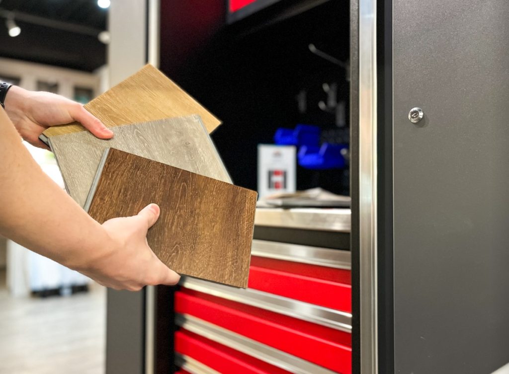 Hands holding rectangular flooring samples