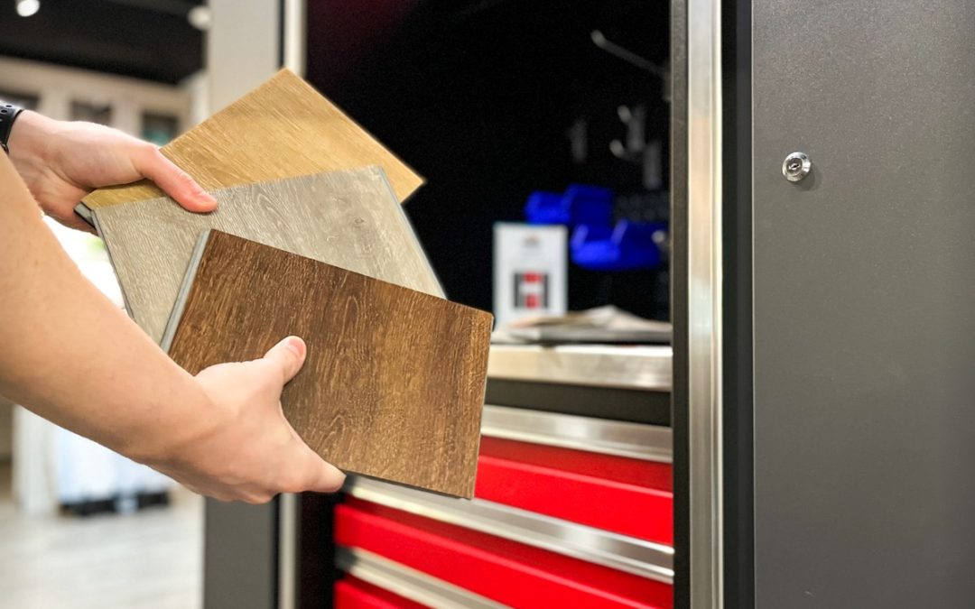 Hands holding rectangular flooring samples